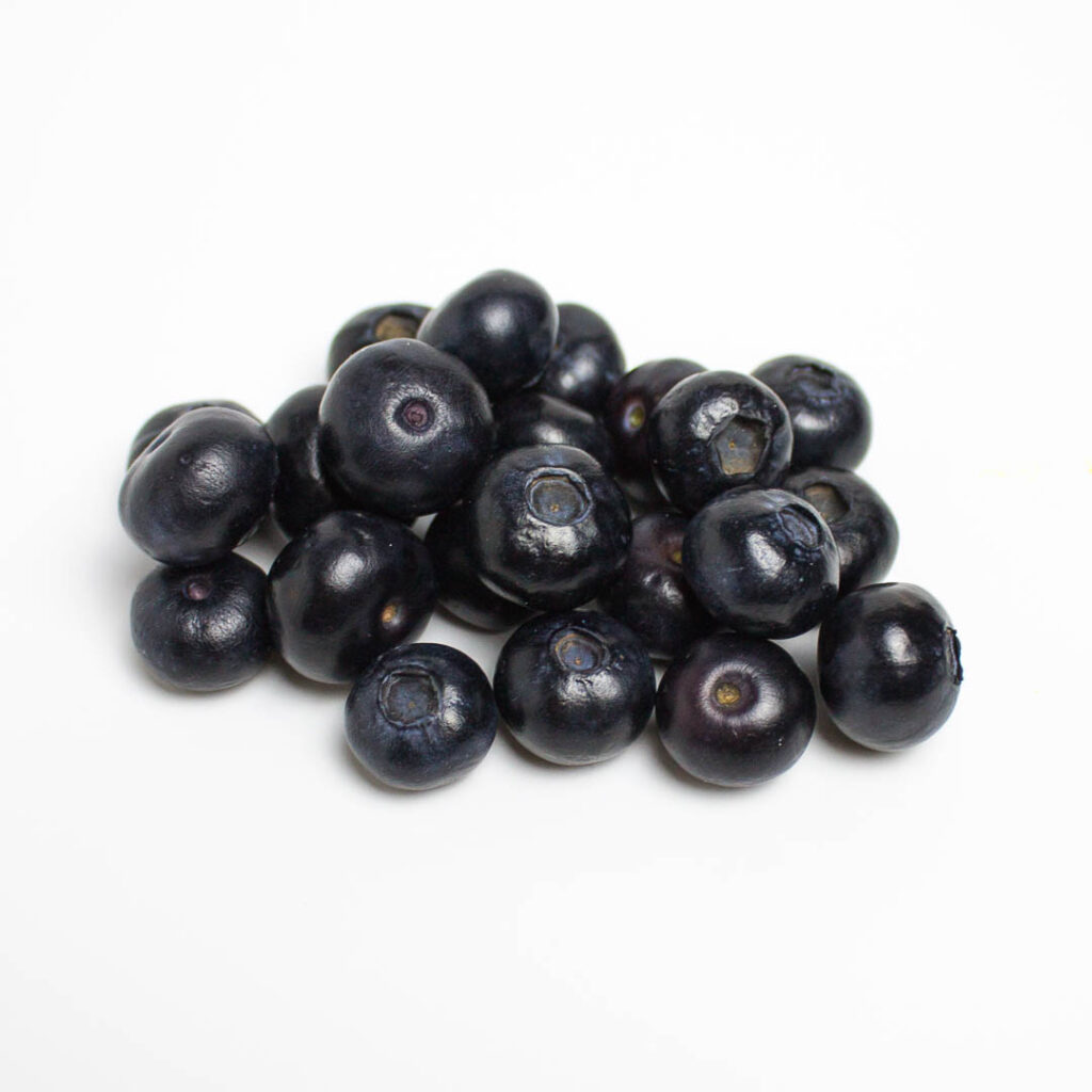 pile of blueberries on a white background