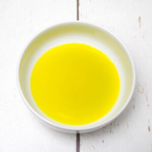 olive oi mixed with lemon juice in a white bowl