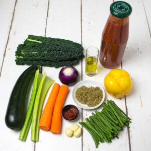 vegetables, dried herbs, olive oil and tomato sauce arranged on a white wooden table