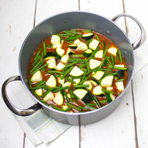 chopped vegetables and tomato sauce in a deep pan