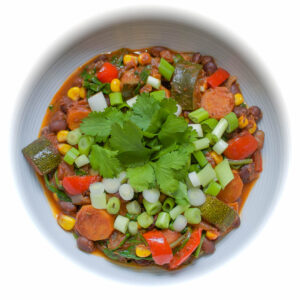 Black bean and vegetable stew in the white bowl