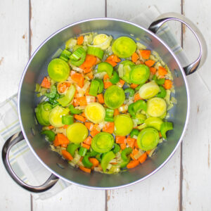 chopped vegetables in a pan on a white table